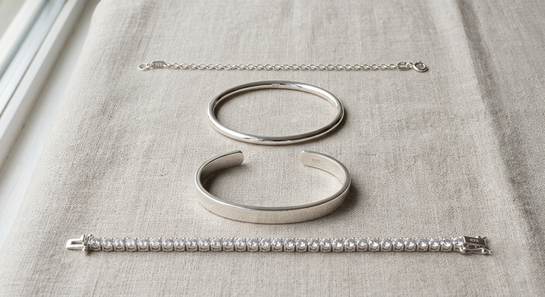 Four 925 sterling silver bracelets in chain, bangle, cuff and tennis styles