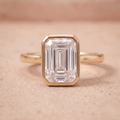 14K emerald bezel set solitaire engagement ring with moissanite