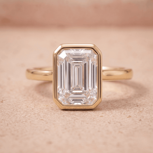 14K emerald bezel set solitaire engagement ring with moissanite