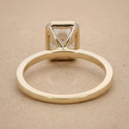 Top view of 14K emerald bezel set solitaire engagement ring