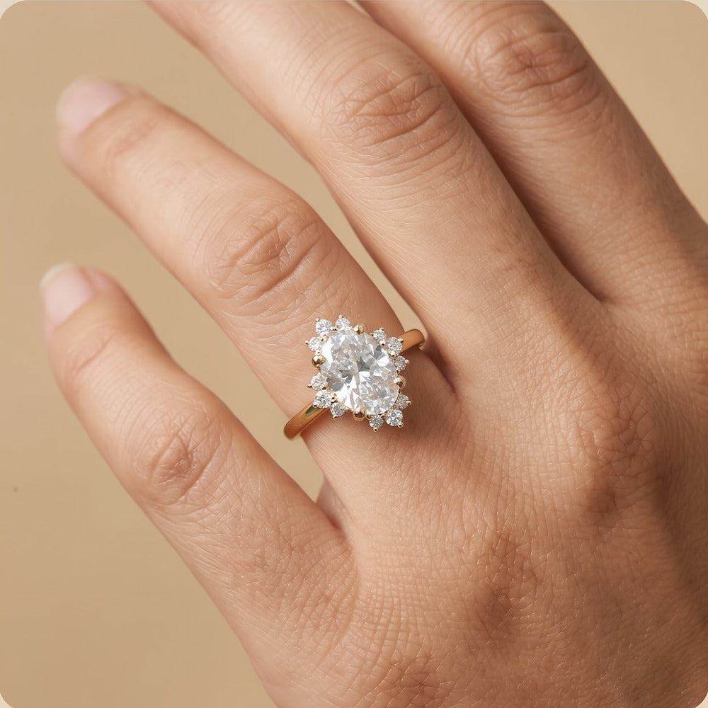 Oval halo engagement ring worn on hand