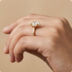 Oval halo engagement ring worn on hand