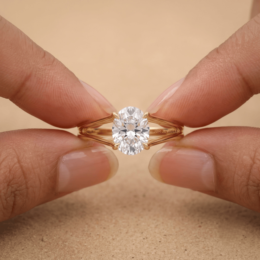 Split shank oval diamond ring in 14K gold on hand