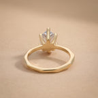 Top view of pear shaped lab grown diamond on 14K gold band