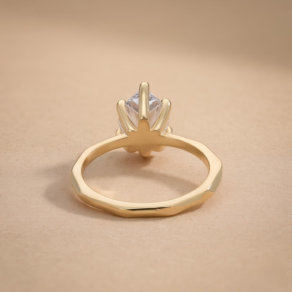 Top view of pear shaped lab grown diamond on 14K gold band