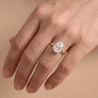 Pear shaped solitaire diamond ring worn on hand, 14K gold band
