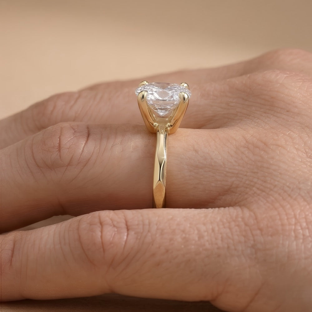 Side view of pear lab grown diamond solitaire in 14K gold band