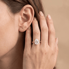 Pear shaped solitaire diamond ring worn on hand Finger, 14K gold band