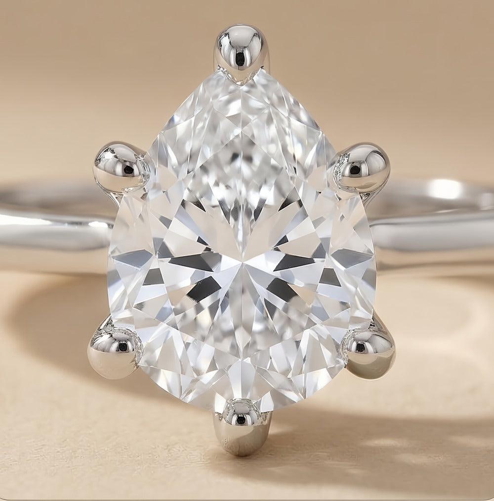 Ethically sourced pear diamond solitaire ring in 14K gold