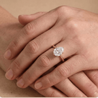 Pear shaped solitaire diamond ring worn on hand, 14K gold band