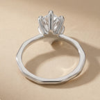Top view of pear shaped lab grown diamond on 14K White gold band