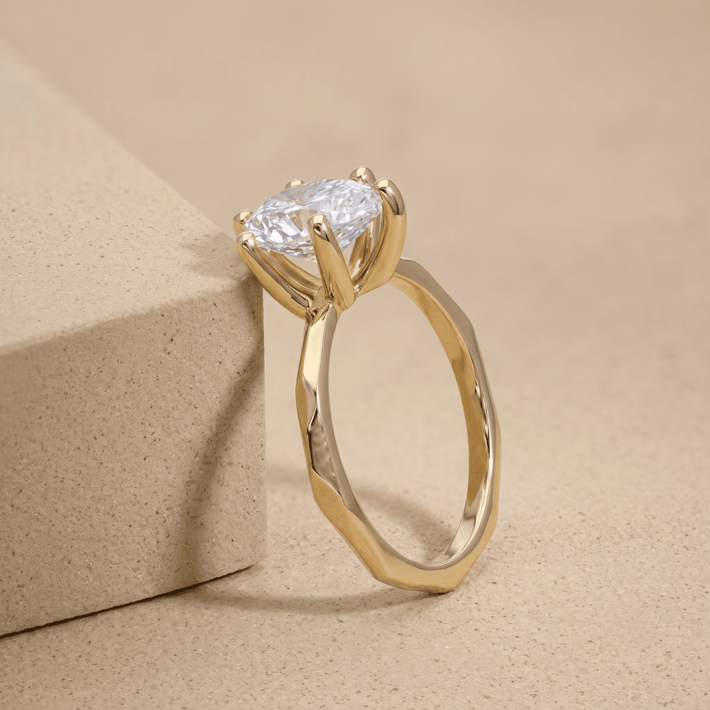Side view of pear lab grown diamond solitaire in 14K gold band