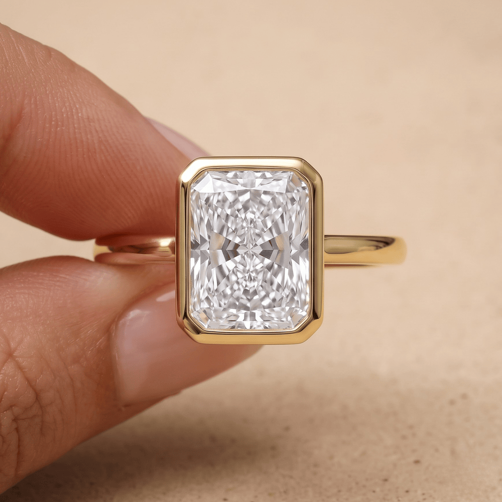 Radiant cut diamond ring worn on hand in 14K gold