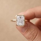 Radiant cut diamond ring worn on hand in 14K gold