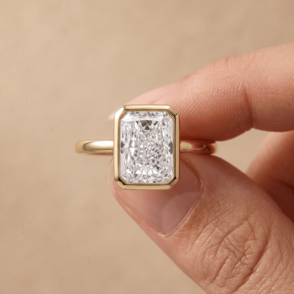 Radiant cut diamond ring worn on hand in 14K gold
