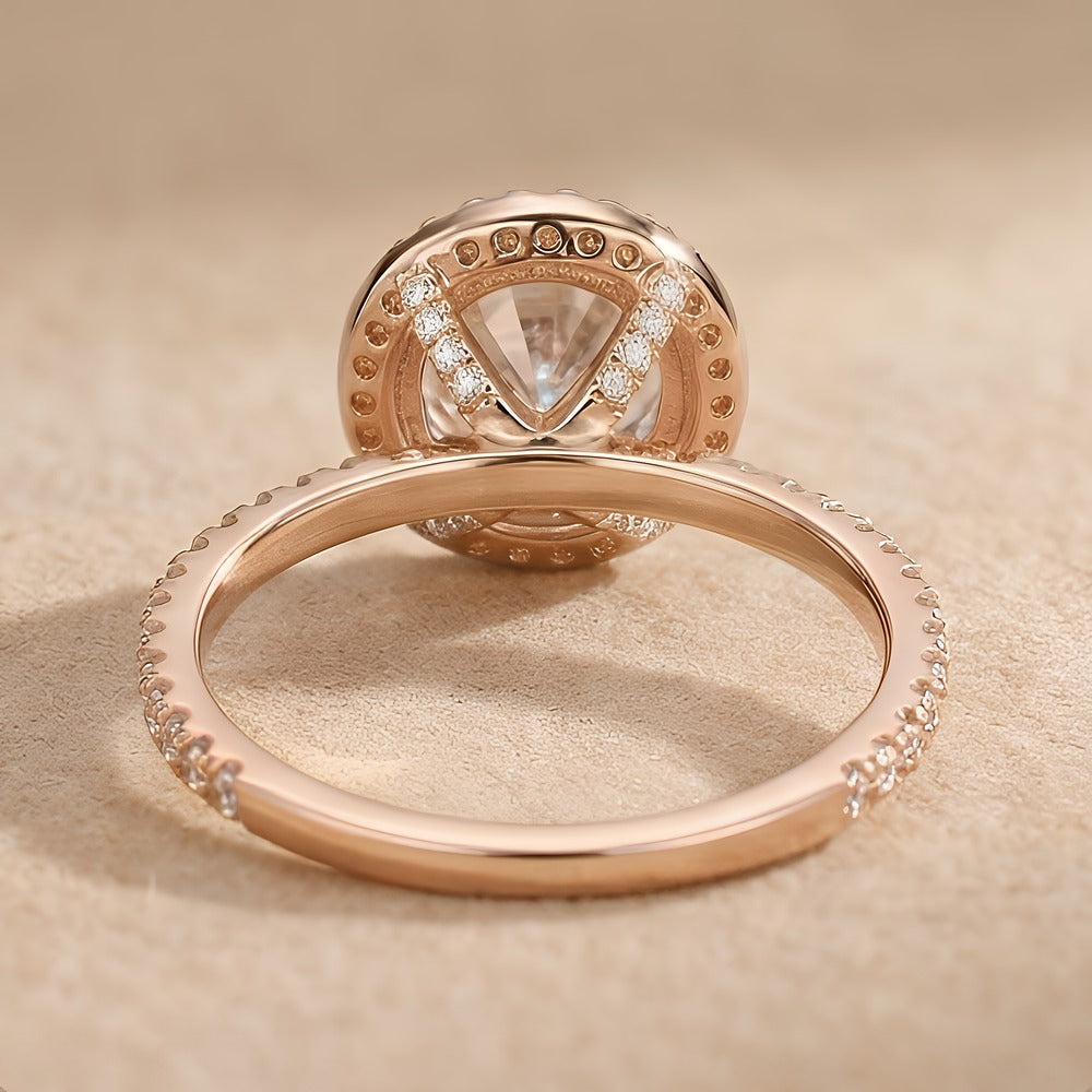 Halo style round cut engagement ring profile view