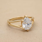 Side view of pear cut lab diamond solitaire gold ring