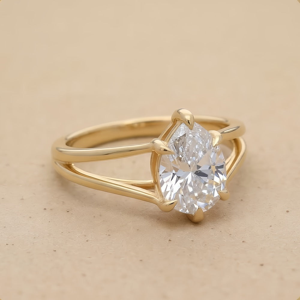 Side view of pear cut lab diamond solitaire gold ring