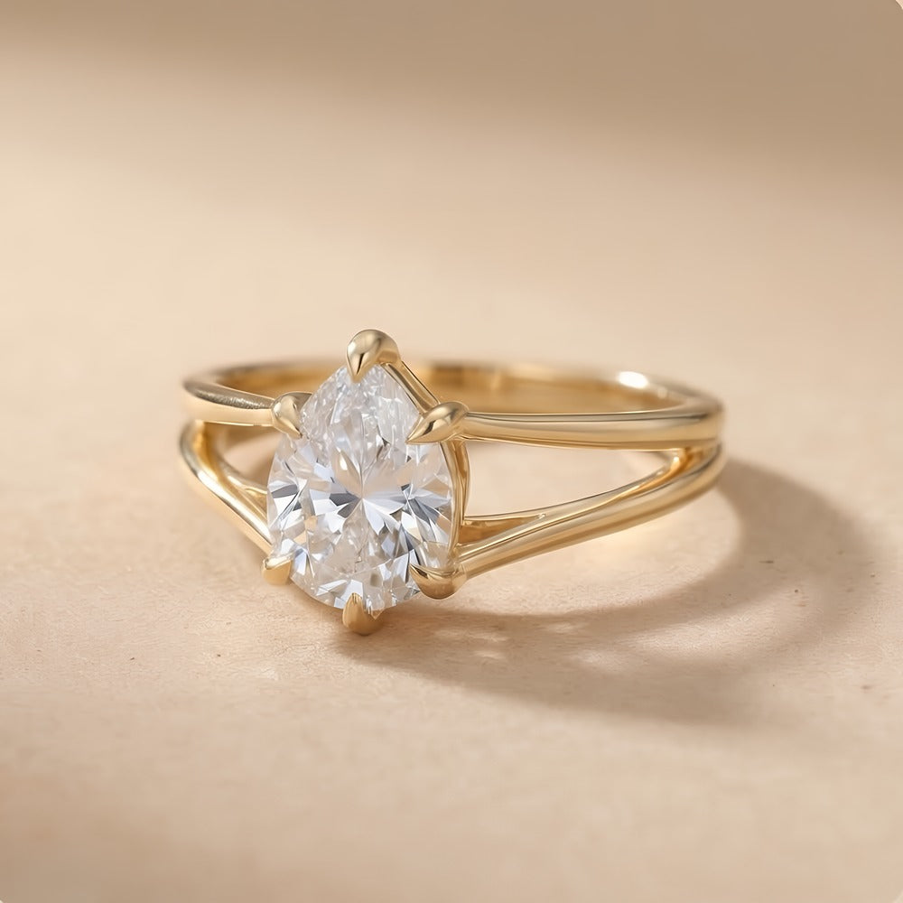 Side view of pear cut lab diamond solitaire gold ring