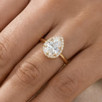Pear moissanite anniversary ring on hand