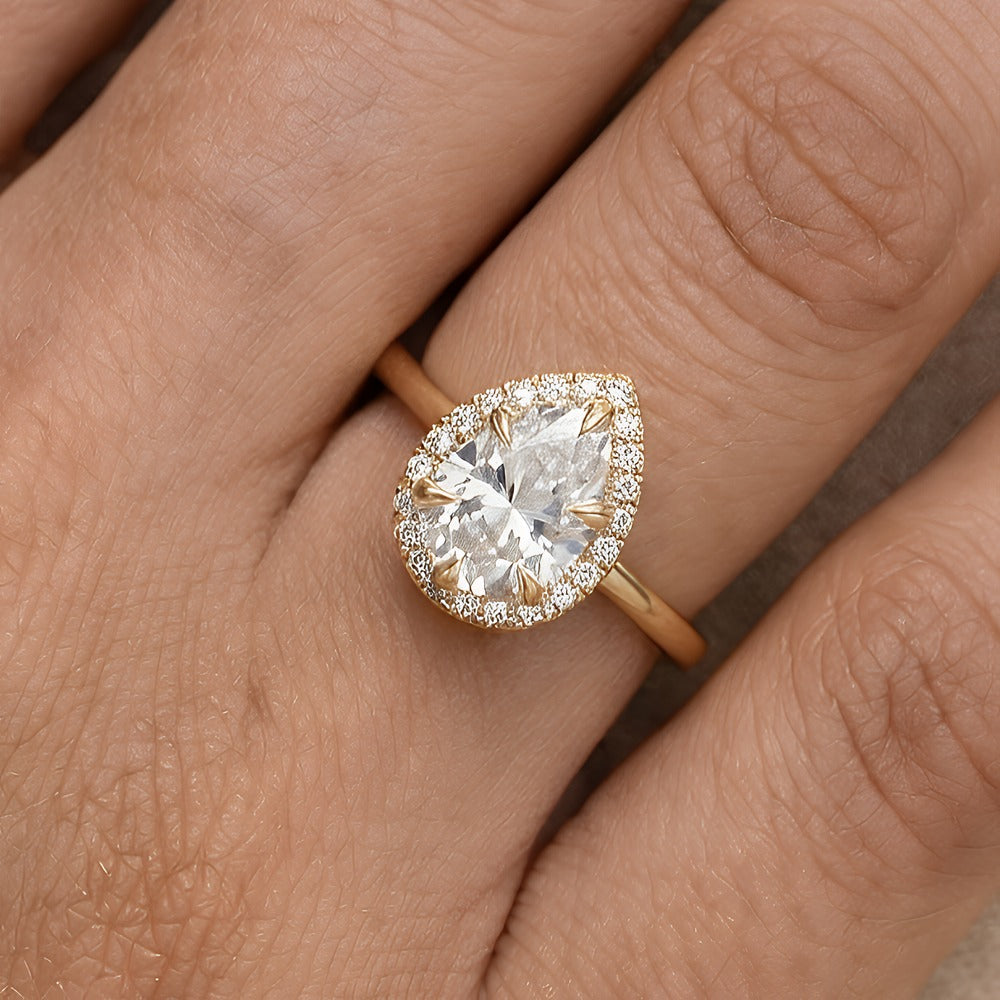 Pear moissanite anniversary ring on hand