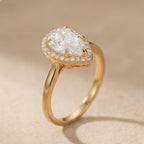 Pear moissanite ring with diamond halo setting