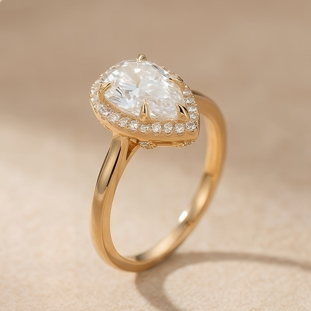 Pear moissanite ring with diamond halo setting