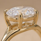East-west curved oval moissanite ring close-up