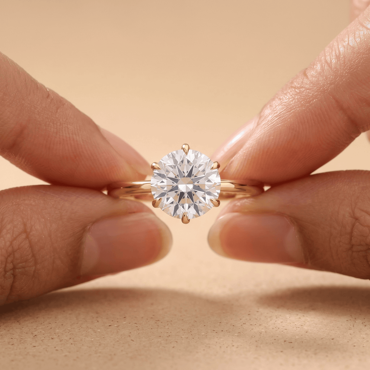 Round diamond engagement ring worn on hand