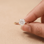 Cushion cut solitaire diamond ring on model's hand