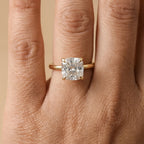 Cushion cut solitaire diamond ring on model's hand