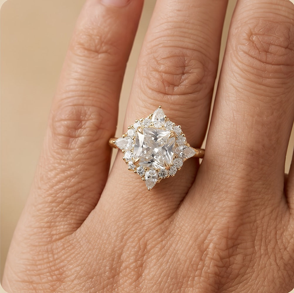 A close-up of a hand wearing a yellow gold ring with a large clear diamond cluster setting.