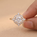 Filigree halo cushion diamond ring on finger