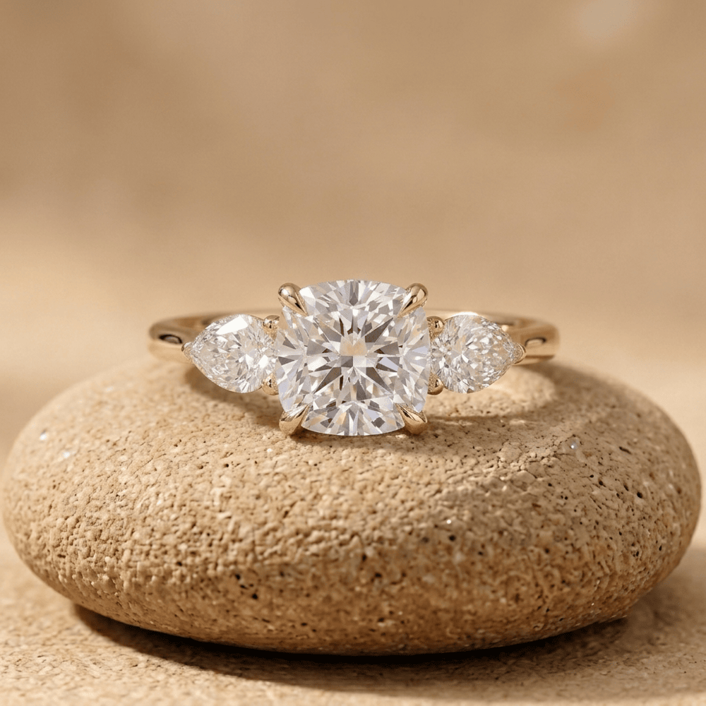 Three stone cushion diamond engagement ring in yellow gold