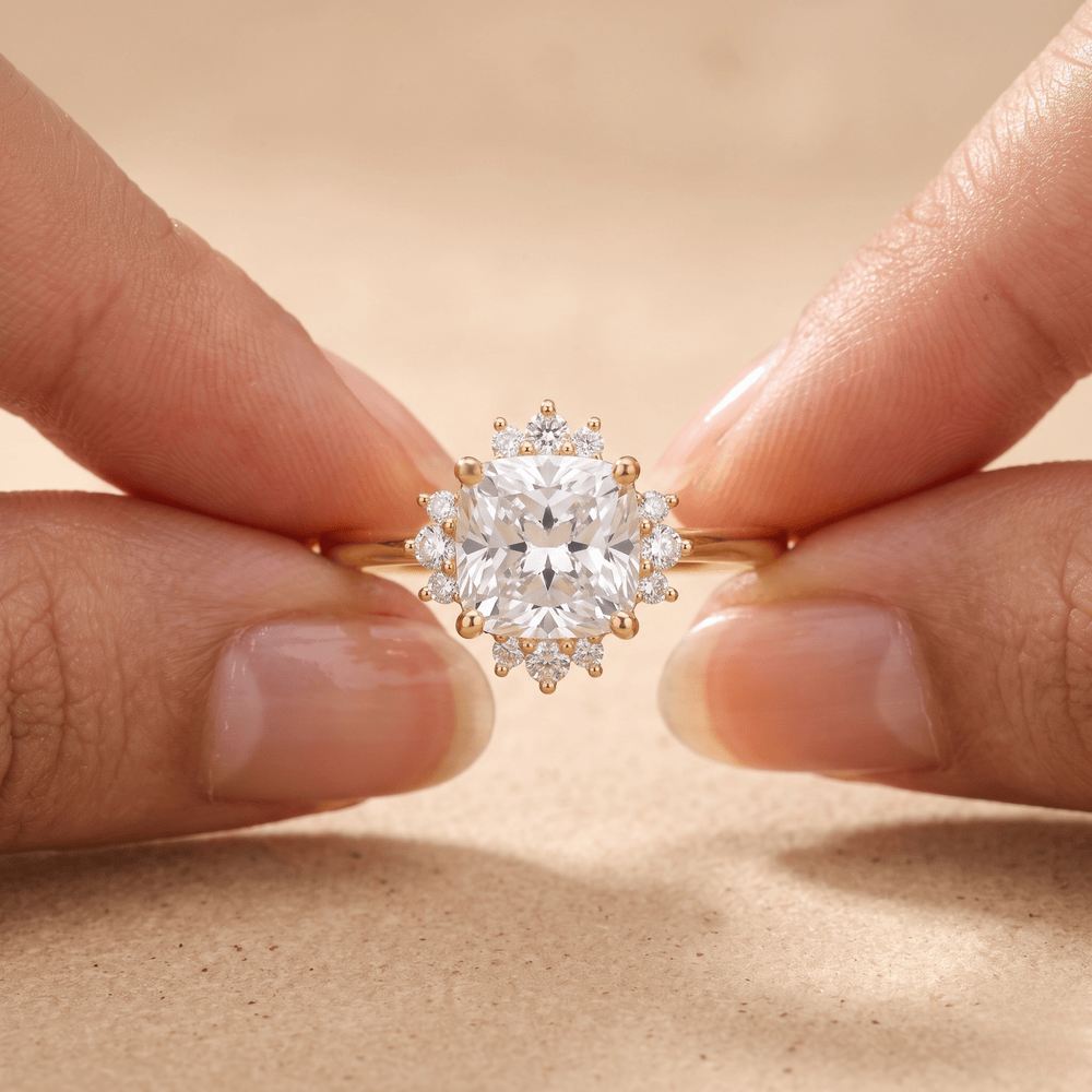 Cushion diamond ring on model's hand outdoor