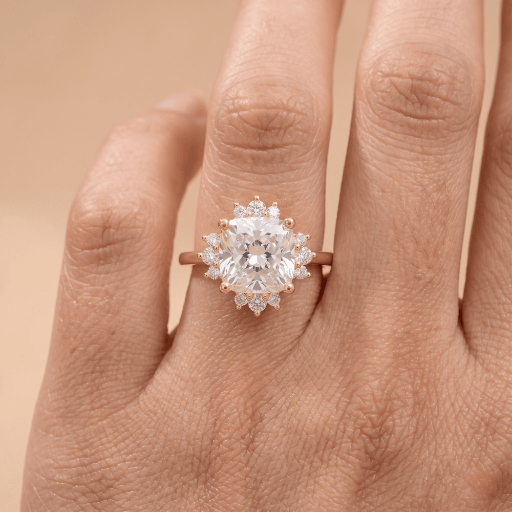 Cushion diamond ring on model's hand outdoor