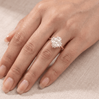 Cushion diamond ring on model's hand outdoor