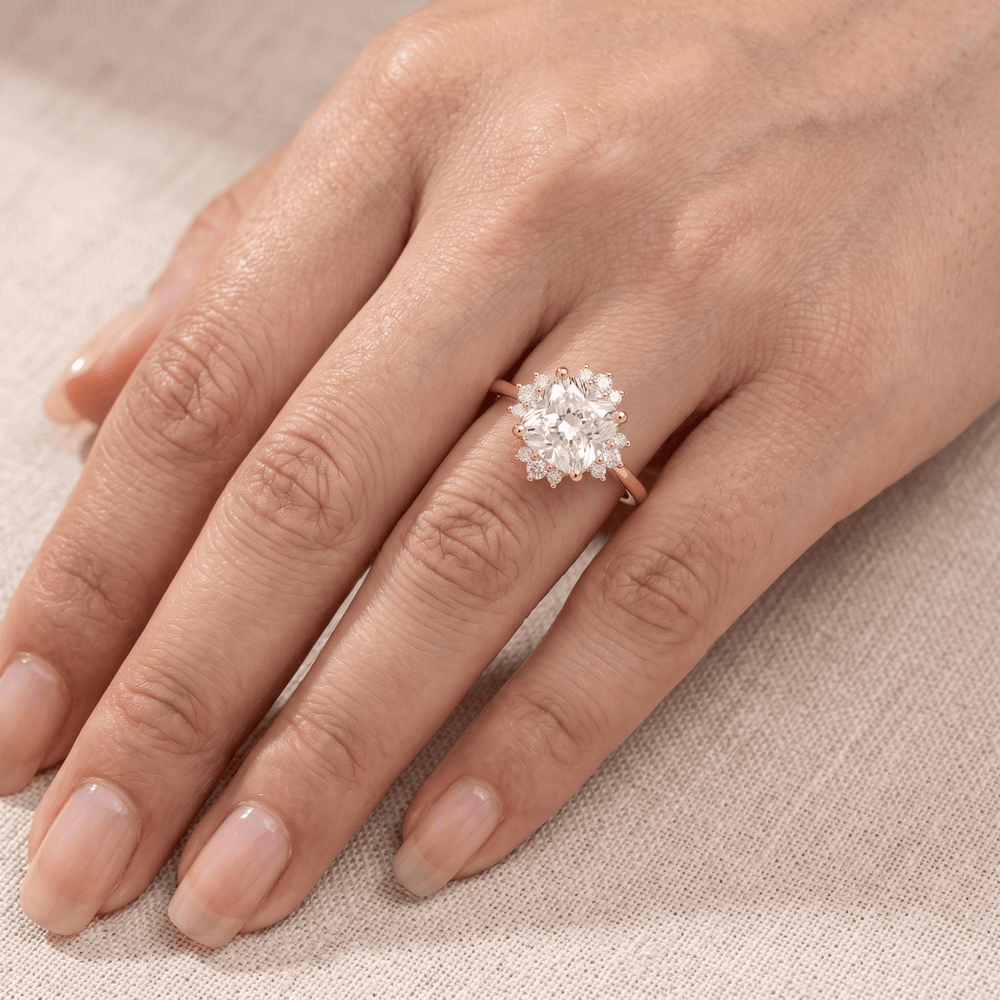 Cushion diamond ring on model's hand outdoor