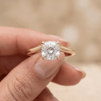 Simple gold cushion cut wedding ring on hand