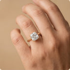Cushion moissanite dual prong ring on model's hand