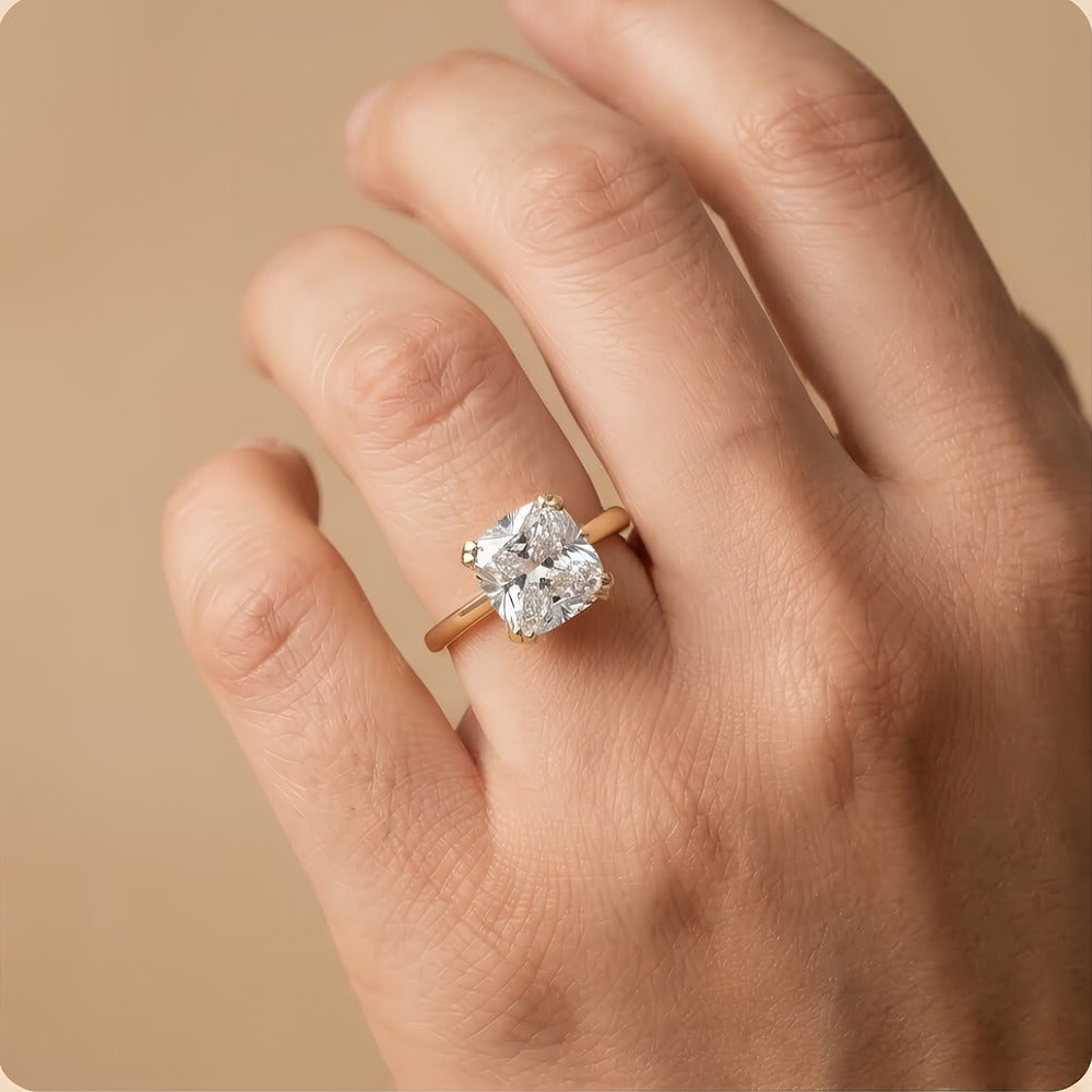 Cushion moissanite dual prong ring on model's hand