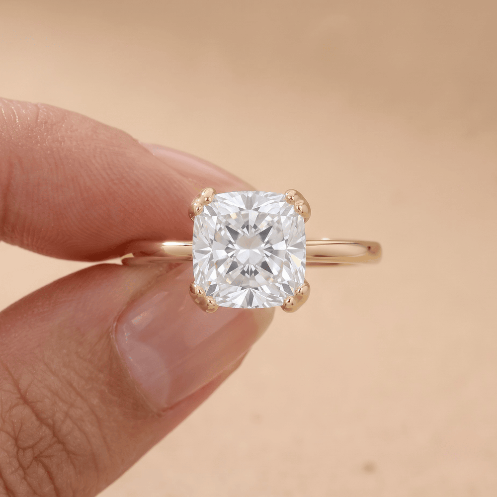 Cushion moissanite dual prong ring on model's hand