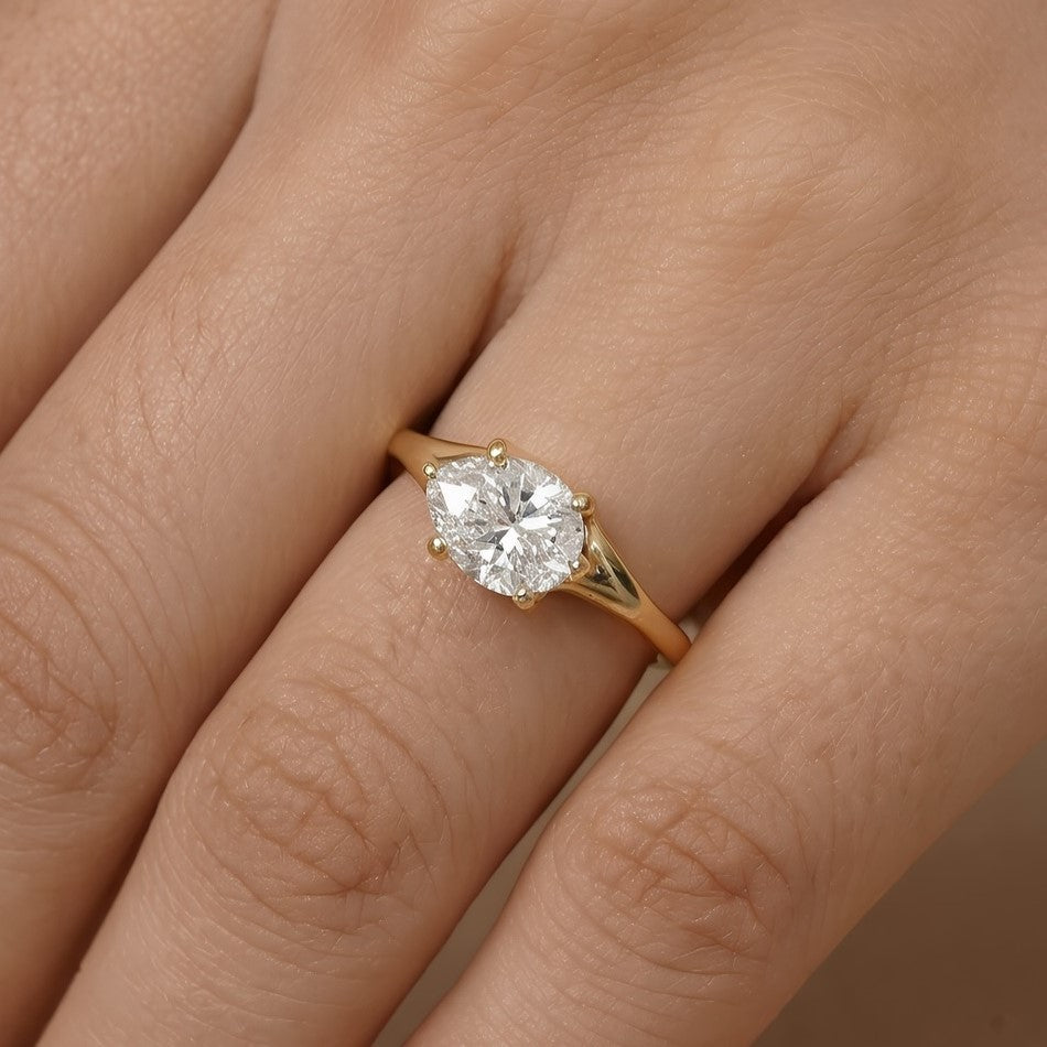 14K rose gold curved band with east-west pear moissanite