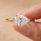 East-west pear moissanite ring styled on model's hand