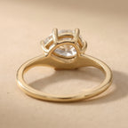 top view of 14K curved band pear moissanite engagement ring