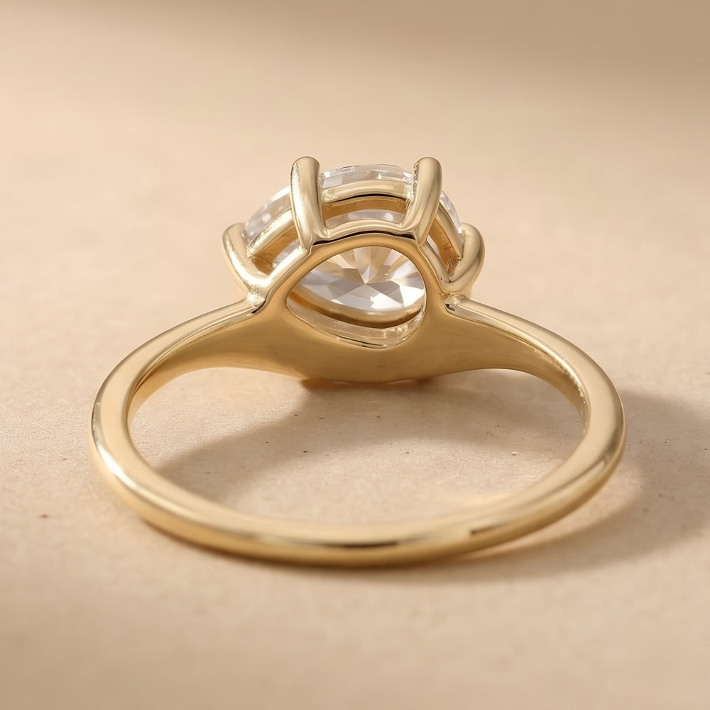 top view of 14K curved band pear moissanite engagement ring