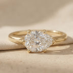 14K gold curved band engagement ring with east-west pear stone