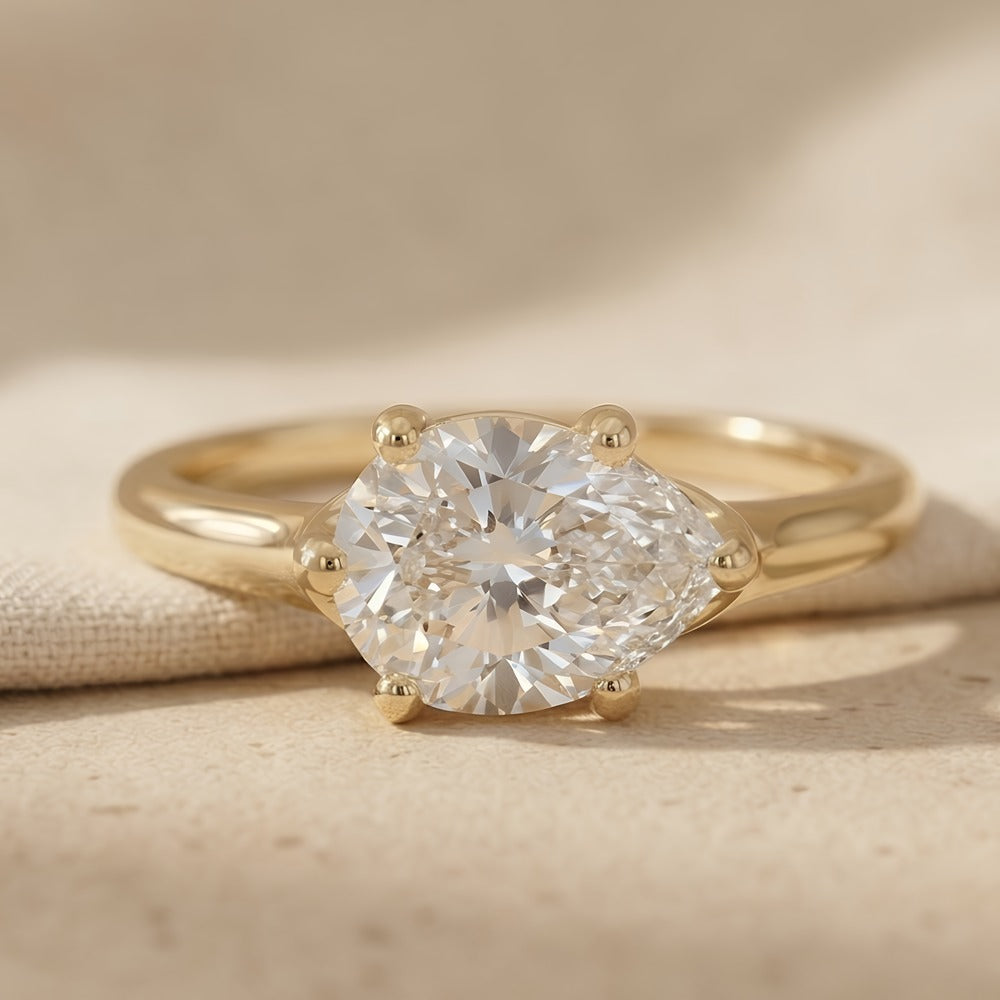 14K gold curved band engagement ring with east-west pear stone