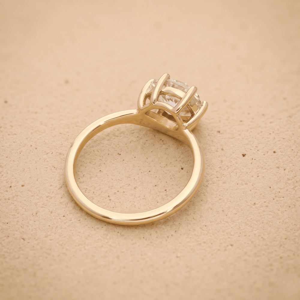 Side view of 14K curved band pear moissanite engagement ring