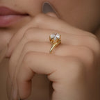 East-west pear moissanite ring styled on model's hand